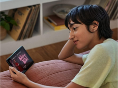 woman watches TV on the Amazon Fire 7 tablet