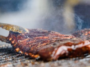 Pictured are ribs being cooked at Prairie Smoke & Spice BBQ poses for a photo in his restaurant at Calgary Stampede Grounds on Wednesday, July 10, 2019. The After Five club is hosting a Ribfest this weekend in the parking lot at CKC Field.