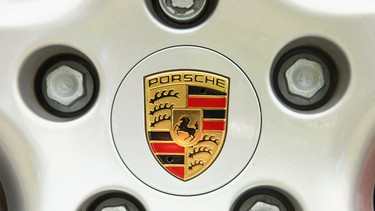 The hood ornament and logo of German automaker Porsche.