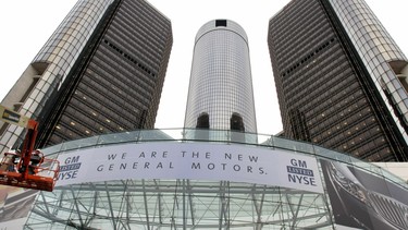 A new banner hangs on the front of the General Motors world headquarters complex to proclaim its return to the New York Stock Exchange (NYSE)  Nov. 18, 2010 in Detroit.