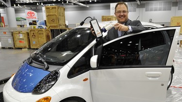 Blair Qualey, President and CEO of New Car Dealers with an iMiEV, a electric car that will be on display at the Vancouver International Auto Show starting March 29th at the Vancouver Convention Centre.