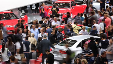 Visitors look at cars displayed on the stand of Audi, the top-of-the-range carmaker owned by German auto giant Volkswagen, during the opening day of the Paris Motor Show on September 29, 2012.