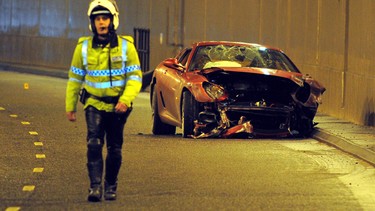 Would a woman have crashed this Ferrari? A policeman walks past the crashed Ferrari car belonging to Manchester United's Cristiano Ronaldo in a tunnel that runs under the Manchester Airport runway in Manchester, northwest England, on January 8, 2009. Ronaldo escaped unscathed from the crash that left his Ferrari a mangled wreck. AFP PHOTO/ANDREW YATES.