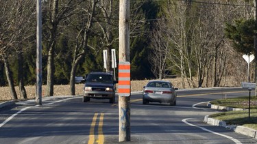 An electric pole stands in the middle of a road in Johnville, Que. (Jocelyn Riendeau/CP/Sherbrooke La Tribune)