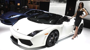 A model stands beside the Lamborghini Gallardo LP 560-4 Spyder during the North American International Auto Show in Detroit.