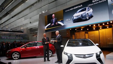 GM Europe President Carl-Peter Forster presents the new Opel Astra (L) and the electric Opel car Ampera during the international motor show.