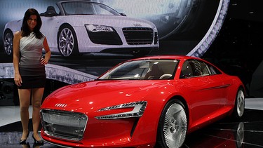 A model poses next to the Audi E-Tron concept car at the international motor show IAA on September 16, 2009 in Frankfurt am Main, Germany. The world's biggest auto show runs until September 27.
