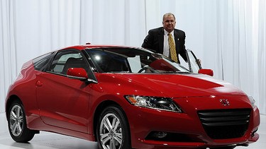 John Mendel, Executive Vice President, American Honda Motor Co., Inc. poses with the Honda CRZ during the first press preview day at the 2010 North American International Auto Show January 11, 2010 at Cobo Center in Detroit, Michigan.