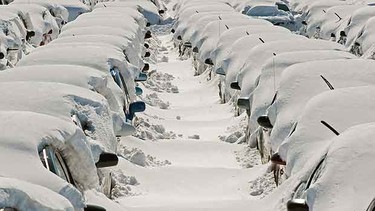 Rental cars wait to be dug out at an auxiliary lot at Dulles International Airport (IAD) where rental cars are buried deep in snow February 8, 2010, 2010, days after the record snowstorm in Washington, DC. Hundreds and hundreds of the cars had to be dug out, one at a time, by hand.