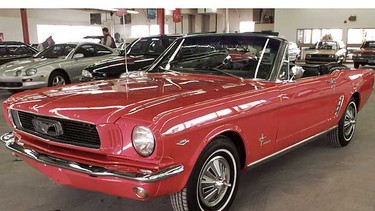 A 1966 Ford Mustang cherry red convertible.