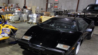 Adam Clarke, a sales rep at the Crown Assets Distribution Centre in Ottawa, takes the driver's seat of a 1987 Lamborghini Countach, just one of numerous sexy items up for bids at the local government auction house.