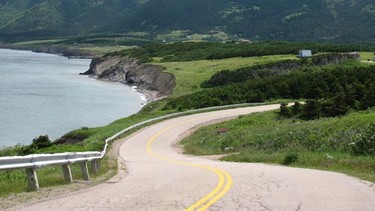 The Cabot Trail is a winding two-lane highway along the coast of Cape Breton, many parts of which are solid double lines.