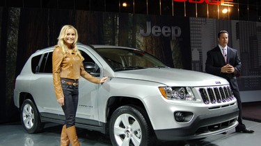 Chrysler Canada CEO Reid Bigland, right, introduces the 2011 Jeep Compass at the Montreal Auto show, noting that the woman does not come with the vehicle.