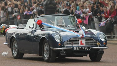 TRH Catherine, Duchess of Cambridge and Prince William, Duke of Cambridge leave at Buckingham Palace in a vintage Aston Martin on April 29, 2011 in London, England.