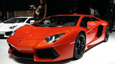 A model posing with a Lamborghini Aventador.