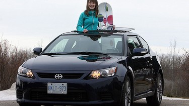 Sian Richards holds her board during her test drive of the new 2011 Scion tC.