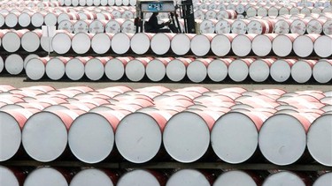 A worker rides a fork lift among drums of lubricants in this file photo.