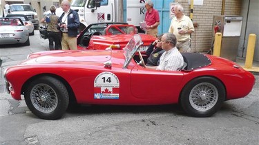 Peter and Zoe Lovett drive away from the Hotel Vancouver in their BMW-powered 1960 AC Bristol.