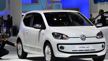 A visitor inspects a VW up! at the Frankfurt Motor Show.