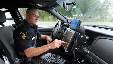 Ontario Provincial Police constable Kirk Jeffery reviews licence plate data collected on an (ALPR) Automatic licence plate recognition system.