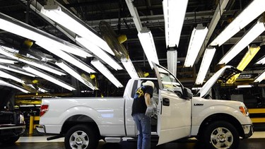A Ford employee works on the final assembly line for the Ford F-150 pickup in this file photo.
