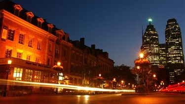 Drivers on Front Street East near St. Lawrence Market at twilight in Toronto. Lots of drivers forget to turn on their headlamps at dusk.