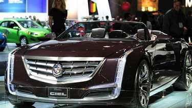 A model stands beside a Cadillac Ciel Concept vehicle displayed at the 2012 Los Angeles Auto Show.
