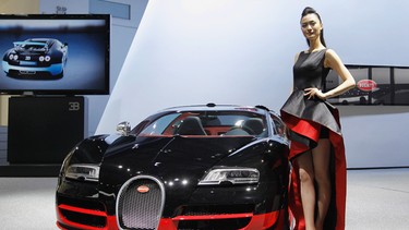 A model stands beside a Bugatti