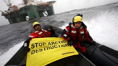 Greenpeace members hold a banner aboard a boat near an oil rig in the Davis Strait, off Greenland's west coast in this photo provided by Greenpeace International. There is a "growing radicalized environmentalist faction" in Canada that is opposed to the country's energy sector policies, warns a newly declassified intelligence report.