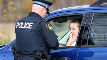 A woman in Windsor is pulled over by police for using a cellphone while driving in this file photo.