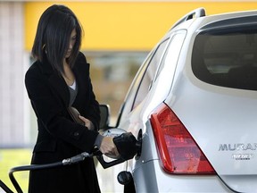 A woman fills her Nissan Murano with gas at a Toronto gas station.