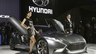 South Korean models pose with a Hyundai Motors HND-9 Venace"during a press day of the Seoul Motor Show.