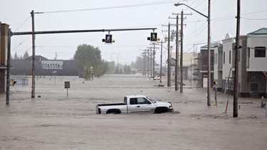 A lone truck sits submerged in the flood waters near downtown High River, Alta. on June 20, 2013 after the Highwood River overflowed its banks.