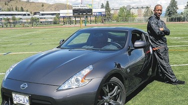 BC Lions' Geroy Simon with a 2010 Nissan 370Z at Hillside Stadium in Kamloops, B.C.