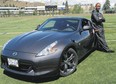 BC Lions' Geroy Simon with a 2010 Nissan 370Z at Hillside Stadium in Kamloops, B.C.