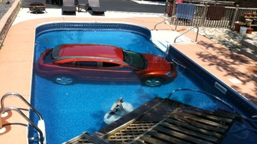 A car has plunged into a backyard pool near the intersection of Wyandotte Street East and Reedmere Road.