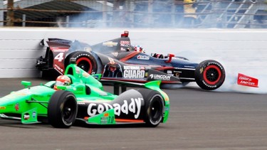 James Hinchcliffe, of Canada, bottom, goes under as JR Hildebrand hits the wall in the first turn during the Indianapolis 500.
