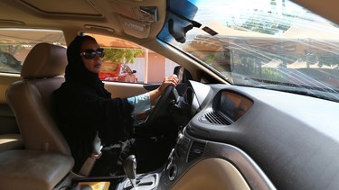 Saudi activist Manal Al Sharif, who now lives in Dubai, drives her Subaru Tribeca in the Gulf Emirate city on October 22, 2013, as she campagins in solidarity with Saudi women preparing to take to the wheel on October 26, defying the Saudi authorities, fight for women's right to drive in Saudi Arabia.
