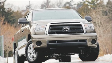 The Tundra's large bumper and outsized grille are matched by huge headlights and raised hood.