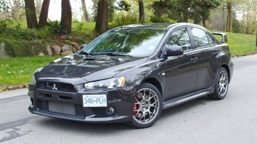 The Mitsubishi Lancer Evolution sports extra cladding on the lower side skirts, and the front grille is large and blacked out to help give the vehicle a more aggressive look.