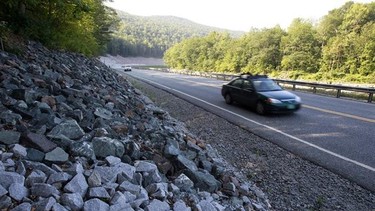 In this Aug. 22, 2013 photo, cars travel on the rebuilt Vermont Route 107 in Bethel, Vt. In what some consider a bit of an engineering marvel, a three-mile section of Route 107 between Bethel and Stockbridge, a major east-west highway that was destroyed by the storm, was rebuilt and reopened in 119 days, a job that normally would have taken two years. Driving in America has stalled, leading researchers to ask: Is the national love affair with the automobile over? After rising for decades, total