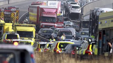 Emergency vehicles attend the scene of a major accident on the Sheppey Bridge Crossing near Sheerness in Kent, south England, following a multi vehicle collision earlier this morning, Thursday Sept. 5, 2013. According to police at the scene around 100-vehicles are involved in the pile-up on a bridge in heavy fog, leaving at least eight people seriously injured after what witnesses described as ''carnage". (AP Photo/Gareth Fuller, PA) UNITED KINGDOM OUT - NO SALES - NO ARCHIVES