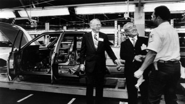 FILE - In this April 4, 1985 file photo, General Motors Chairman Roger B. Smith, left, and Toyota Motor Corp. Chairman Eiji Toyoda, second right, greet a worker on the assembly line at New United Motor Manufacturing Co, Inc., plant in Fremont, Calif., when dedication ceremonies for the $400 million joint venture were held. Toyoda, a member of Toyota's founding family who helped create the super-efficient "Toyota Way" production method, has died. He was 100. The automaker said Toyoda, a cousin of