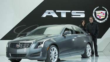 The Cadillac ATS wins the North American Car of the Year Award Monday, January 14, 2013 at the start of the North American International Auto Show in Detroit, Michigan. Standing with the Cadillac ATS are General Motors Vice President Global Product Development Mary Barra (left) and GM North America President Mark Reuss.