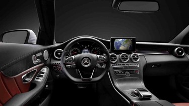 The interior of the 2015 C-Class features swoopy, black lines and a prominent central display.