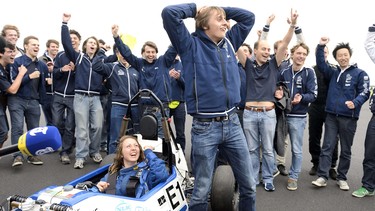 Driver Marly Kuijpers, left, celebrates with the team of Delft University of Technology on Sept. 20, 2013, in Leiden, after beating the acceleration world record for an electric car, with 2.15 seconds.