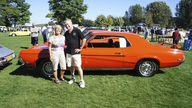 Marlene and Harry Unruh with the restored competition orange 1969 Cougar Eliminator they purchased new August 1, 1969.