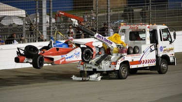 The car of Justin Wilson of England driver of the #19 Dale Coyne Racing Dallara Honda gets towed after a crash during the IZOD IndyCar Series MAVTV 500 World Championship at the Auto Club Speedway on October 19, 2013 in Fontana, California.