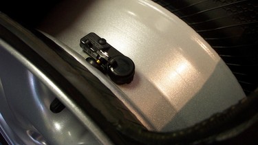 A tire pressure monitoring system is affixed to a tire in this file photo.
