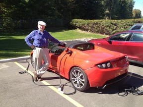 Alfred Cassidy with his son-in-law’s 2010 Tesla Roadster 2.0.